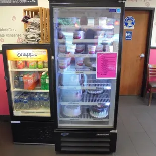 Display coolers with beverages, pints to-go, and ice cream cakes.