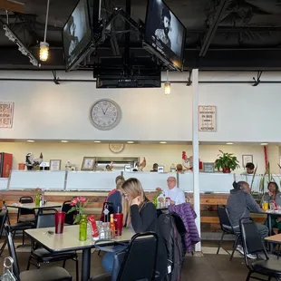 eople sitting at tables in a restaurant