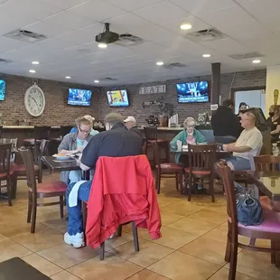 people sitting at tables in a restaurant