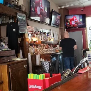 two men standing at a bar
