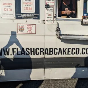 the shadow of a person behind a food truck