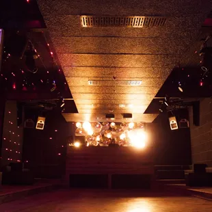 a dimly lit room with a chandelier hanging from the ceiling