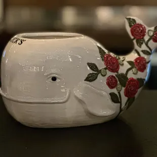 a ceramic whale with roses on it