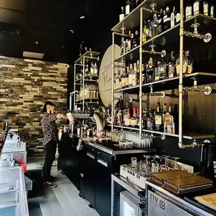 a man standing in front of the bar