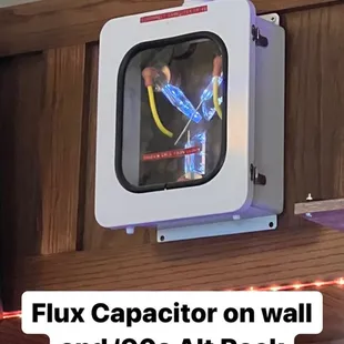 a tv mounted on the wall above a bar