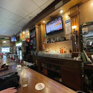 a bar with people sitting at the bar