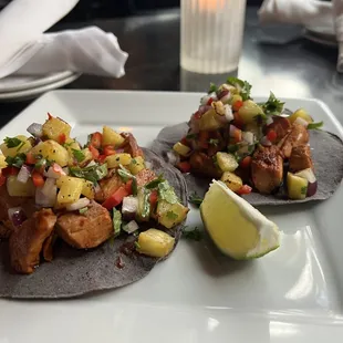 Barbacoa Tacos 
shredded beef cooked in adobo wrapped in banana leaves, corn tortilla, pickled red onions, cilantro, lime