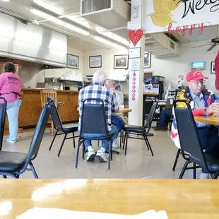 people sitting at tables in a restaurant