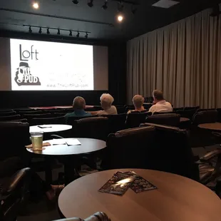 people sitting in chairs watching a movie
