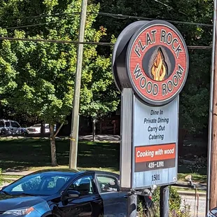 a car parked in front of the sign