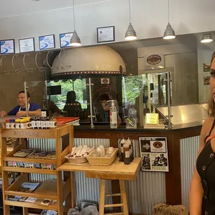 a woman standing in front of a counter