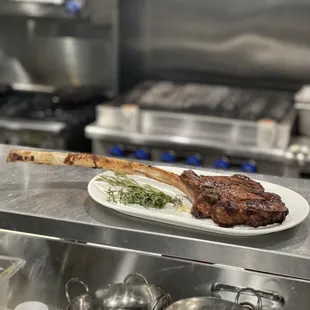 Tomahawk 32oz.  Butcher Block upper 2/3 choice USDA Ribeye W / Frenched bone-in. Served with butter and rosemary