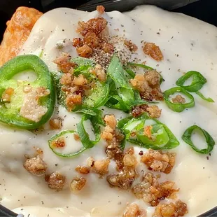 Jalapeño cheddar biscuit, topped with sausage, gravy, chives, and fresh jalapeño slices