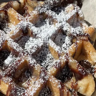 a waffle with powdered sugar on top
