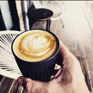 a hand holding a cup of coffee