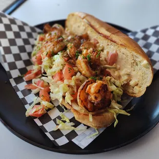 a hot dog with shrimp and coleslaw