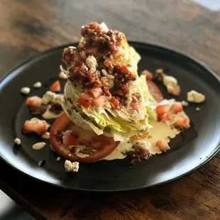 a wedge of lettuce topped with tomatoes and cheese