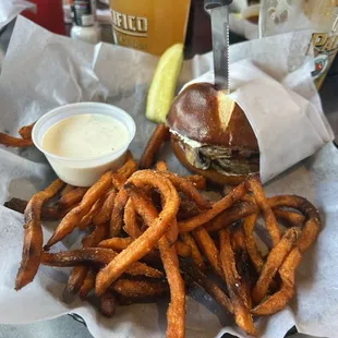 Mushroom burger on pretzel bun with sweet potato fries