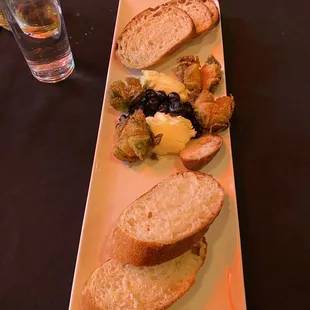 Bread board, caramelized blueberries, homemade bread, salty butter, fried brussels sprouts