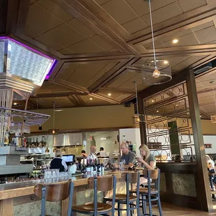 Bar area and open kitchen behind.