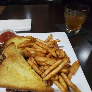 Brisket grilled cheese sandwich with fries.
