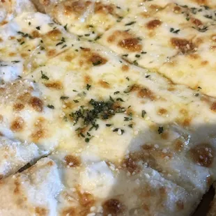 a pizza with cheese and herbs