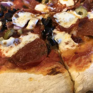 a pizza with pepperoni and olives