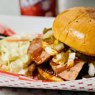 a close up of a sandwich and coleslaw