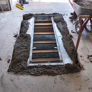 Concrete is poured around, under and on top of the shelter.