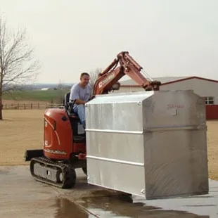a man on a tractor with a loader