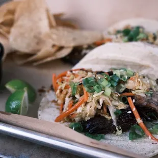two tacos and chips on a tray