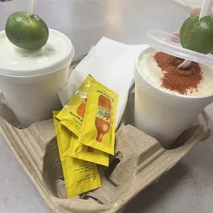two cups of ice cream and a lime
