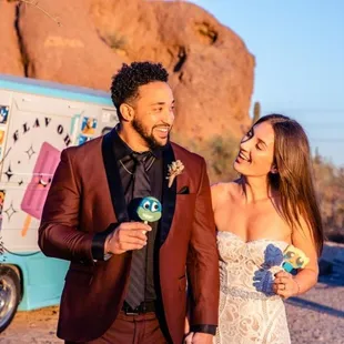 a bride and groom standing in front of an ice cream truck