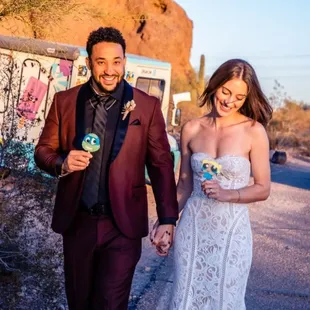 a bride and groom walking down the street