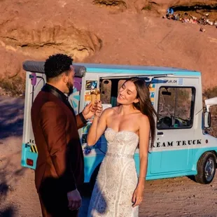 a man and a woman standing in front of an ice cream truck