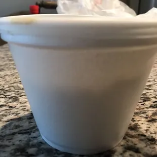 a white cup on a granite countertop