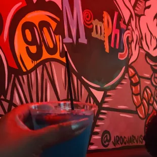 a person holding a drink