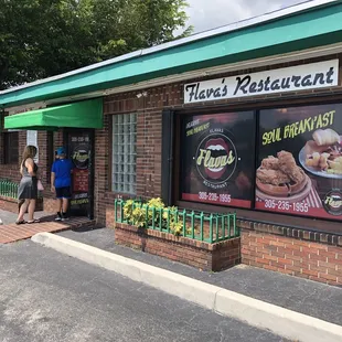 a woman standing outside of a restaurant