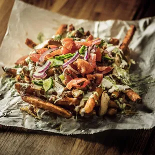 gyro fries, newest addition (seasoned fries, cheese, yogurt sauce,  grilled chicken  tonpped with tonato and cucumber salad)