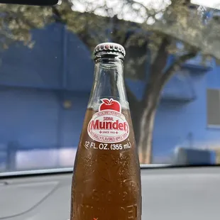 a bottle of mundich on the dashboard of a car