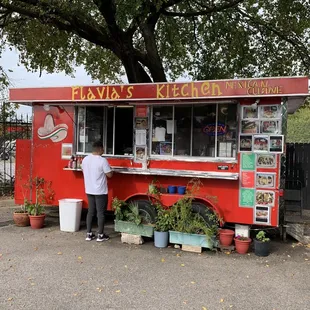 a man standing in front of a food truck