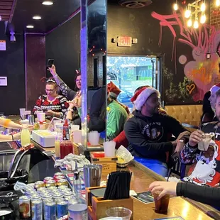 a group of people sitting at a bar