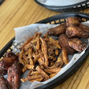 a basket of chicken wings and fries