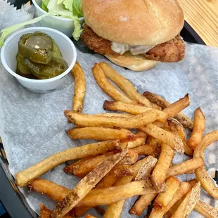 Fried chicken sandwich with reg. Fries. Candied jalapeños and lettuce on side.