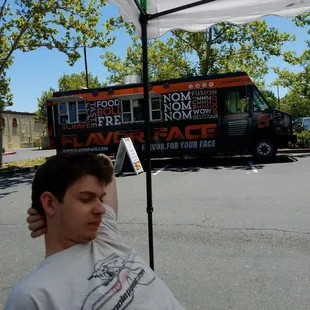 a man sitting under an umbrella