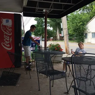 Out front under the awning.
