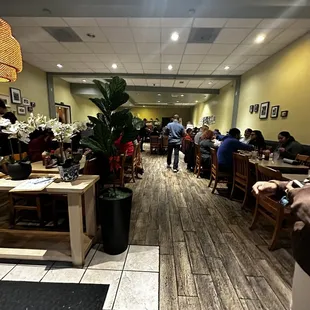 people sitting at tables in a restaurant