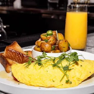 an omelet, toast, and orange juice