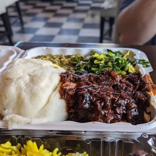 Ugali with curried lentils, collard greens, and spicy jerk chicken