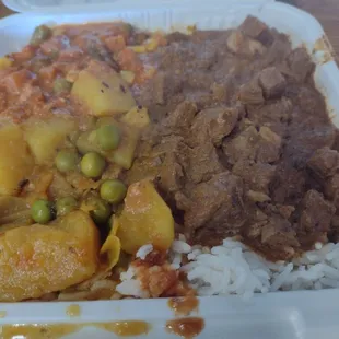 Goat curry and veggies over white rice